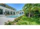 A modern home with a backyard oasis featuring a beautiful pool, spa, lush landscaping, and a cabana at 1607 Flower Dr, Sarasota, FL 34239