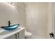 Stylish powder room featuring a unique blue glass vessel sink and modern fixtures at 1607 Flower Dr, Sarasota, FL 34239