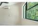 A bright room with a large window and views of lush greenery, perfect for relaxing and enjoying the natural light at 1607 Flower Dr, Sarasota, FL 34239