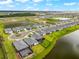 Aerial view of a neighborhood featuring homes with screened-in patios and waterfront views, surrounded by lush landscaping at 18317 Gulf Ranch Pl, Bradenton, FL 34211
