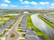 Aerial view showcasing a neighborhood with waterfront homes, lush landscaping, and a community lake at 18317 Gulf Ranch Pl, Bradenton, FL 34211