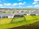 Aerial view of waterfront homes featuring screened patios, lush green lawns, and a black fence to the water edge at 18317 Gulf Ranch Pl, Bradenton, FL 34211