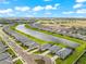 Aerial view of a neighborhood with waterfront homes, lush landscaping, and a community lake at 18317 Gulf Ranch Pl, Bradenton, FL 34211