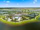 Gorgeous aerial view of the community resort style pool, clubhouse, tennis courts, and surrounding neighborhood at 18317 Gulf Ranch Pl, Bradenton, FL 34211