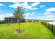 Expansive backyard with well-manicured lawn and view of the lake, creating a beautiful outdoor space at 18317 Gulf Ranch Pl, Bradenton, FL 34211