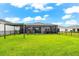 Spacious backyard with a covered patio and well-maintained lawn, perfect for outdoor activities and relaxation at 18317 Gulf Ranch Pl, Bradenton, FL 34211