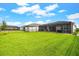 Large backyard with lush lawn, patio, and pergola offers an ideal space for outdoor relaxation and entertaining at 18317 Gulf Ranch Pl, Bradenton, FL 34211