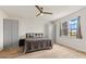This bedroom features wood floors, a ceiling fan, a bed with gray and white bedding, and two gray wardrobe closets at 18317 Gulf Ranch Pl, Bradenton, FL 34211