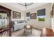 Cozy bedroom featuring stylish furnishings, three windows with modern blinds, and wood-look flooring at 18317 Gulf Ranch Pl, Bradenton, FL 34211