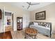 Bedroom featuring stylish furnishings, two entry doors, and a glass display case with wood-look flooring at 18317 Gulf Ranch Pl, Bradenton, FL 34211