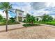 Beautifully landscaped clubhouse entrance with manicured garden and brick paver walkway at 18317 Gulf Ranch Pl, Bradenton, FL 34211