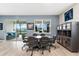 Modern dining room with grey walls, wood floors, and access to a screened-in patio with a lake view at 18317 Gulf Ranch Pl, Bradenton, FL 34211