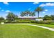 Star Farms entrance with lush landscaping, palm trees, and a welcoming community sign at 18317 Gulf Ranch Pl, Bradenton, FL 34211