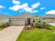 Charming single-story home with stone accents, a well-manicured lawn, and a paved driveway leading to a two-car garage at 18317 Gulf Ranch Pl, Bradenton, FL 34211