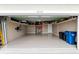 Spacious two car garage with epoxy flooring, overhead storage and an electric vehicle charging outlet at 18317 Gulf Ranch Pl, Bradenton, FL 34211