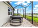Backyard view of a hot tub with steps, set within a screened-in patio with a view of the lake at 18317 Gulf Ranch Pl, Bradenton, FL 34211