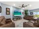 Open concept living room features comfortable leather couches, a flat screen television, and accent wall at 18317 Gulf Ranch Pl, Bradenton, FL 34211