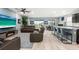 Open concept living room features comfortable leather couches, a flat screen television, and bar seating at 18317 Gulf Ranch Pl, Bradenton, FL 34211