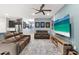 Comfortable living room with plush seating, modern decor, and a large screen television at 18317 Gulf Ranch Pl, Bradenton, FL 34211