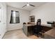 Bright office space featuring a modern desk, ample storage, and neutral décor with wood-look flooring at 18317 Gulf Ranch Pl, Bradenton, FL 34211
