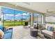 Inviting screened-in patio with ample seating, ceiling fans, and views of the lush backyard at 18317 Gulf Ranch Pl, Bradenton, FL 34211