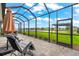 Enjoy the peaceful water views from this covered patio with comfortable seating area, ideal for relaxing outdoors at 18317 Gulf Ranch Pl, Bradenton, FL 34211