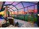 Spectacular sunset view from the covered patio with outdoor seating, a perfect spot for evening relaxation and entertainment at 18317 Gulf Ranch Pl, Bradenton, FL 34211