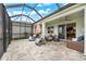 Relaxing screened-in patio area with cozy seating and ceiling fan provides great views to the backyard and beyond at 18317 Gulf Ranch Pl, Bradenton, FL 34211