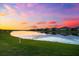 Gorgeous backyard water view at sunset, creating a serene and peaceful backdrop for outdoor enjoyment and relaxation at 18317 Gulf Ranch Pl, Bradenton, FL 34211