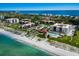 Stunning beachfront community with a private beach, pool, and lush green landscaping at 2045 Gulf Of Mexico Dr # M1-505, Longboat Key, FL 34228