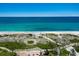Breathtaking aerial view of the beach, dunes, and pathway, showcasing this prime oceanfront property at 2045 Gulf Of Mexico Dr # M1-505, Longboat Key, FL 34228