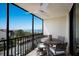 Enjoy the ocean view on this balcony with a ceiling fan and comfortable seating area at 2045 Gulf Of Mexico Dr # M1-505, Longboat Key, FL 34228