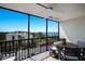 Balcony with dining set overlooking community landscape and views of the ocean at 2045 Gulf Of Mexico Dr # M1-505, Longboat Key, FL 34228