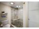 Contemporary bathroom with a shower featuring stylish tile work and a glass door at 2045 Gulf Of Mexico Dr # M1-505, Longboat Key, FL 34228