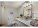Bright bathroom featuring modern fixtures, a large mirror and a single sink vanity at 2045 Gulf Of Mexico Dr # M1-505, Longboat Key, FL 34228