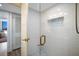 Modern bathroom with a tiled shower, gold hardware and a glass door at 2045 Gulf Of Mexico Dr # M1-505, Longboat Key, FL 34228