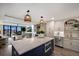 Bright, open kitchen with a center island and modern appliances, adjacent to an airy living space at 2045 Gulf Of Mexico Dr # M1-505, Longboat Key, FL 34228