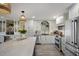 Modern kitchen features white cabinetry, stainless steel appliances and hardwood style flooring at 2045 Gulf Of Mexico Dr # M1-505, Longboat Key, FL 34228