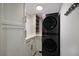 Laundry room featuring modern appliances, white cabinets and stylish hardware at 2045 Gulf Of Mexico Dr # M1-505, Longboat Key, FL 34228
