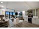 Living room with access to a balcony and adjacent built-in bar and cabinetry at 2045 Gulf Of Mexico Dr # M1-505, Longboat Key, FL 34228