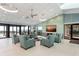 Bright and airy lounge area with comfortable seating, fireplace, and ocean views at 2045 Gulf Of Mexico Dr # M1-505, Longboat Key, FL 34228