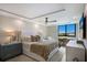 Bright main bedroom featuring a ceiling fan, a large window and a stylish area rug at 2045 Gulf Of Mexico Dr # M1-505, Longboat Key, FL 34228