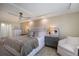 Bright main bedroom featuring a ceiling fan, a large closet and a cozy armchair at 2045 Gulf Of Mexico Dr # M1-505, Longboat Key, FL 34228