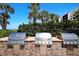 Outdoor kitchen featuring stainless steel grills, perfect for alfresco dining and entertaining at 2045 Gulf Of Mexico Dr # M1-505, Longboat Key, FL 34228