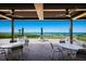 Charming outdoor patio with comfortable seating and stunning views of the beach at 2045 Gulf Of Mexico Dr # M1-505, Longboat Key, FL 34228