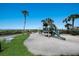 Charming playground with swings, slide, and playhouse, surrounded by lush landscaping at 2045 Gulf Of Mexico Dr # M1-505, Longboat Key, FL 34228