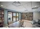 Well-stocked reading room with built-in bookshelves and patio access for relaxation and leisure at 2045 Gulf Of Mexico Dr # M1-505, Longboat Key, FL 34228
