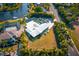 Bird's-eye view of a waterfront property with a pool, manicured lawn, and a private boat dock at 2159 Constitution Blvd, Sarasota, FL 34231