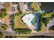 Aerial view of a well-manicured property featuring a pool, lush landscaping, and a spacious driveway at 2159 Constitution Blvd, Sarasota, FL 34231