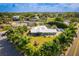 Waterfront property with beautiful landscaping, complemented by a stunning home exterior and boat dock at 2159 Constitution Blvd, Sarasota, FL 34231